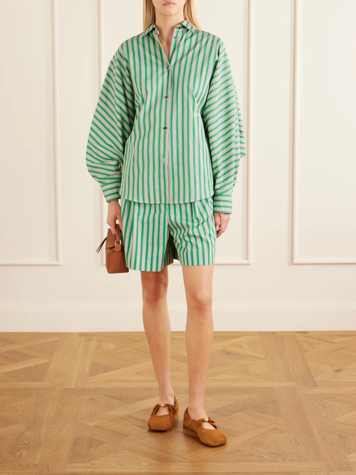 Image of a model wearing Shorts. Product name - Striped Pleated Cotton-poplin Shorts in Green colour by brand - LOEWE