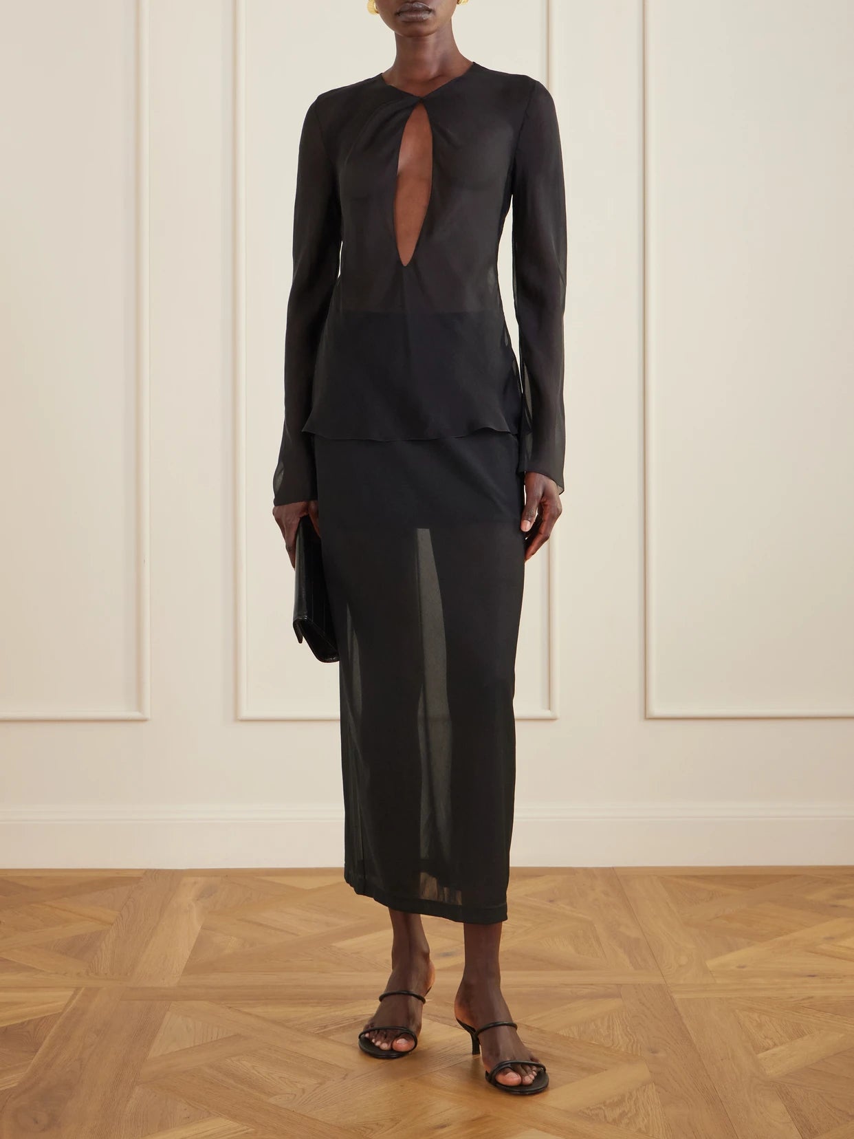 Image of a model wearing Tops. Product name - Cut-out Silk-chiffon Blouse in Black colour by brand - Colleen Allen