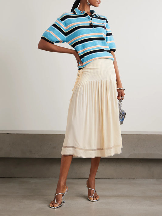 Image of a model wearing Skirts. Product name - Tie-detailed Pleated Crepe Midi Skirt in Ecru colour by brand - RABANNE