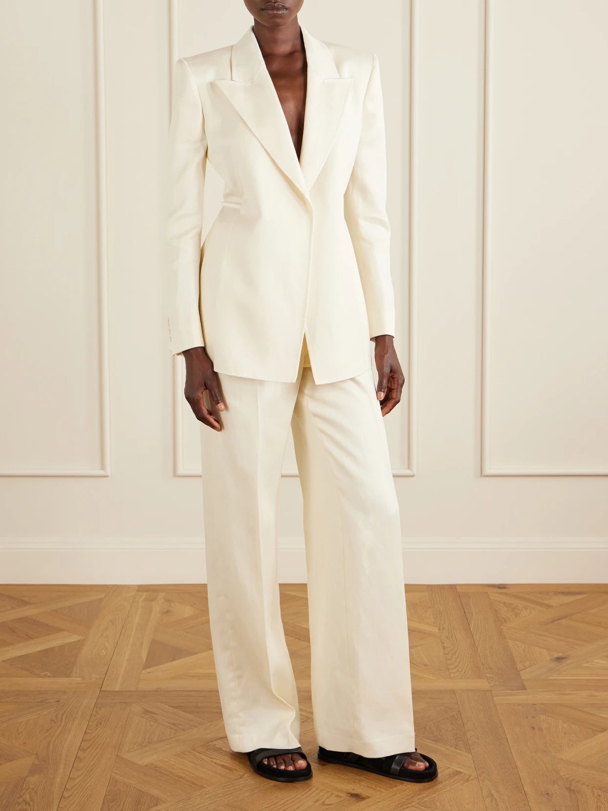 Image of a model wearing Outerwear. Product name - Epona Belted Linen Blazer in Ivory colour by brand - Gabriela Hearst