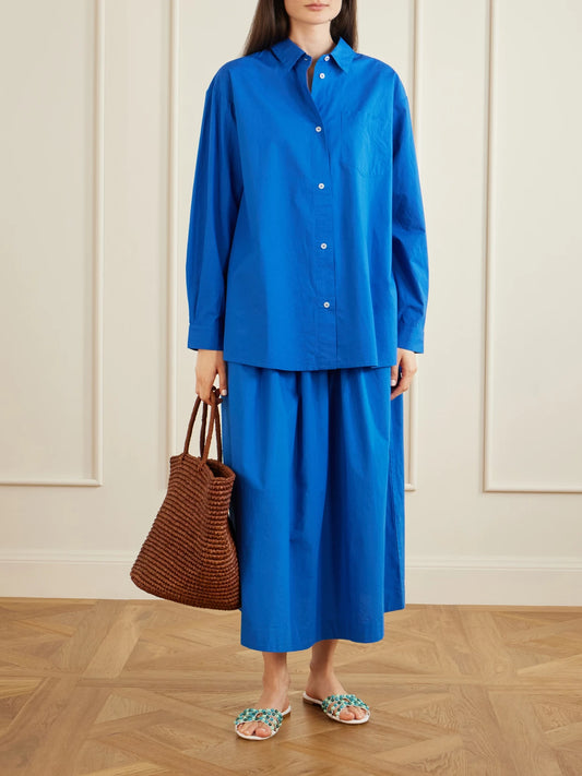 Image of a model wearing Skirts. Product name - Dagny Organic Cotton-poplin Midi Skirt in Blue colour by brand - SKALL