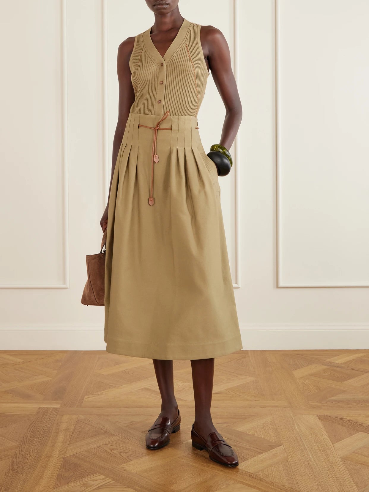 Image of a model wearing Skirts. Product name - Mxmtempio Belted Pleated Leather-trimmed Cotton Midi Skirt in Taupe colour by brand - Max Mara