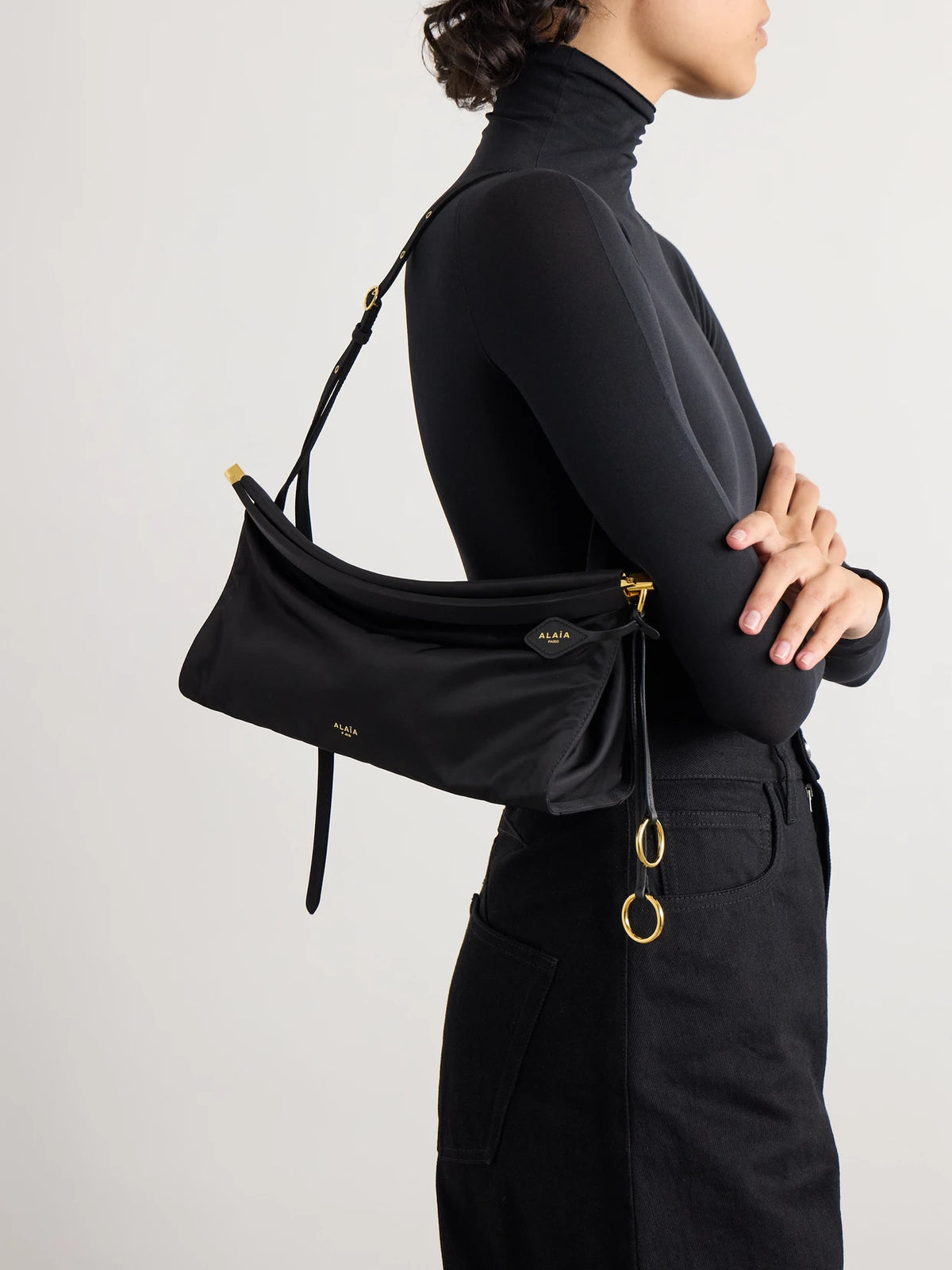 Image of Bags. Product name - Le Click E/w Medium Satin-twill Shoulder Bag in Black colour by brand - Alaïa