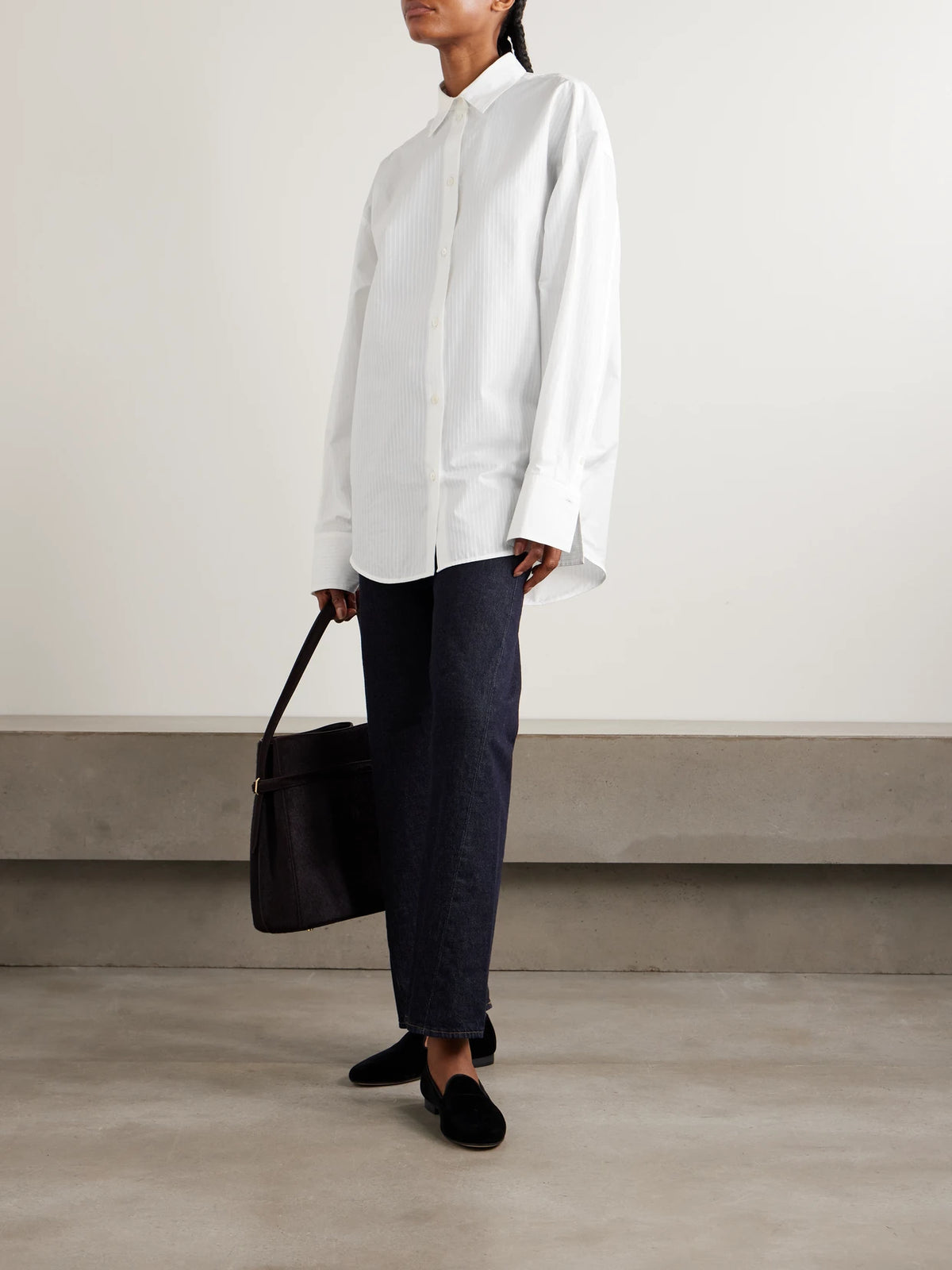 Image of a model wearing Tops. Product name - Striped Cotton Shirt in White colour by brand - TOTEME