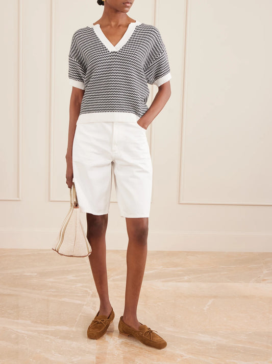 Image of a model wearing Outerwear. Product name - Dora Striped Knitted Cotton Top in Black colour by brand - Varley