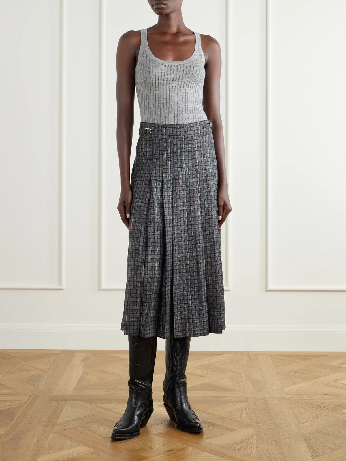 Image of a model wearing Skirts. Product name - Wesley Pleated Houndstooth Wool And Cashmere-blend Twill Midi Skirt in Gray colour by brand - Gabriela Hearst