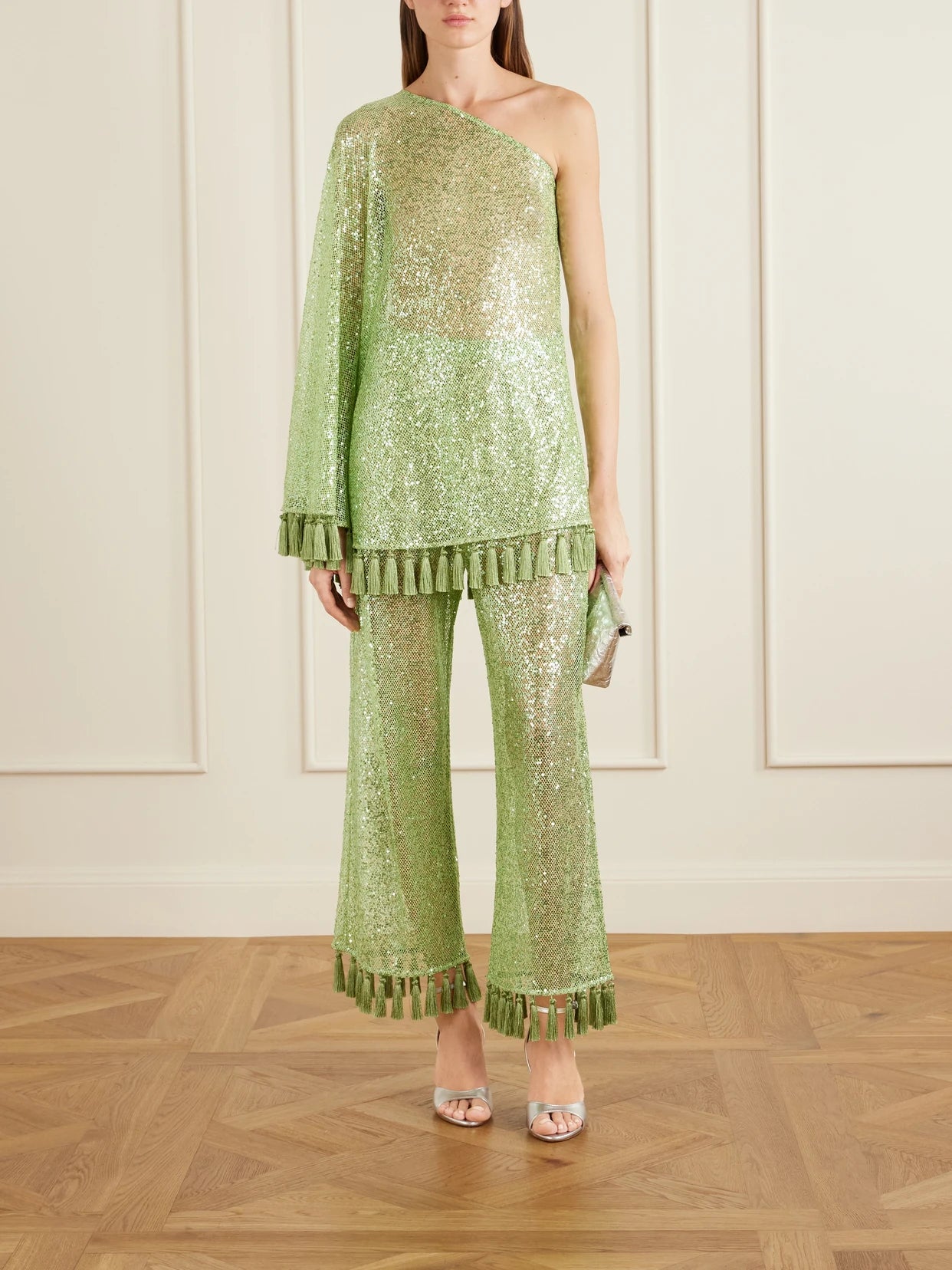 Image of a model wearing Pants. Product name - Sequined Fringed Flared Pants in Green colour by brand - Taller Marmo