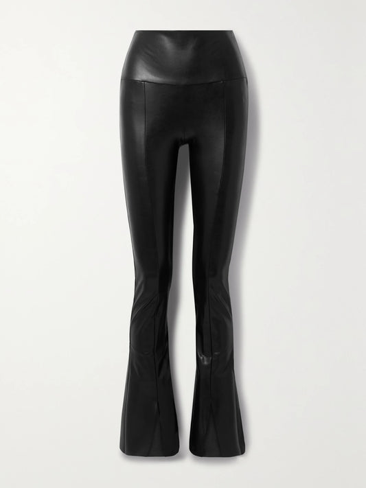 Image of a model wearing Pants. Product name - Spat Vegan Leather Flared Leggings in Black colour by brand - Norma Kamali