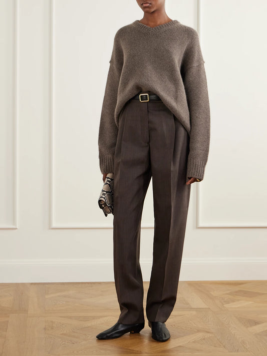Image of a model wearing Pants. Product name - Daria Pleated Virgin Wool Tapered Pants in Brown colour by brand - RÓHE