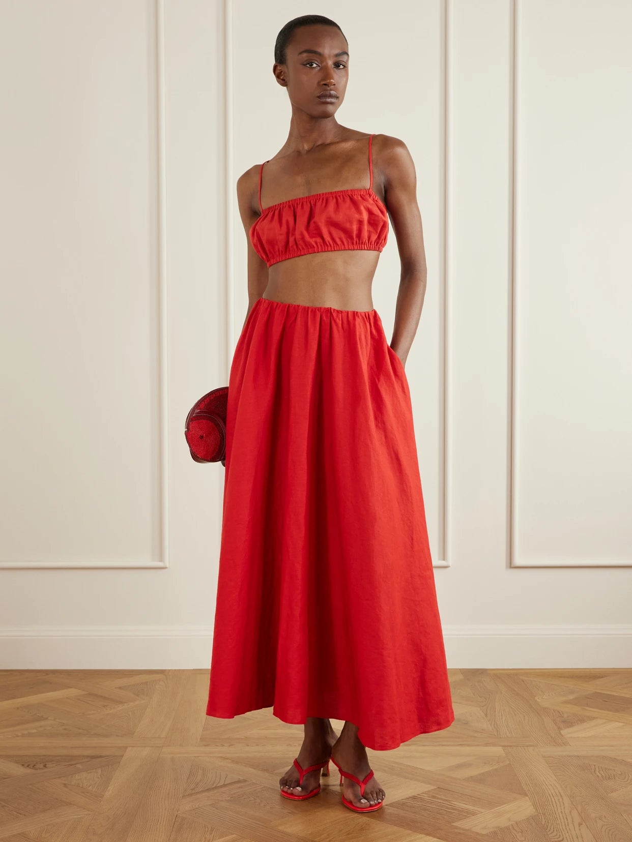 Image of a model wearing Skirts. Product name - Milano Linen Maxi Skirt in Red colour by brand - STAUD
