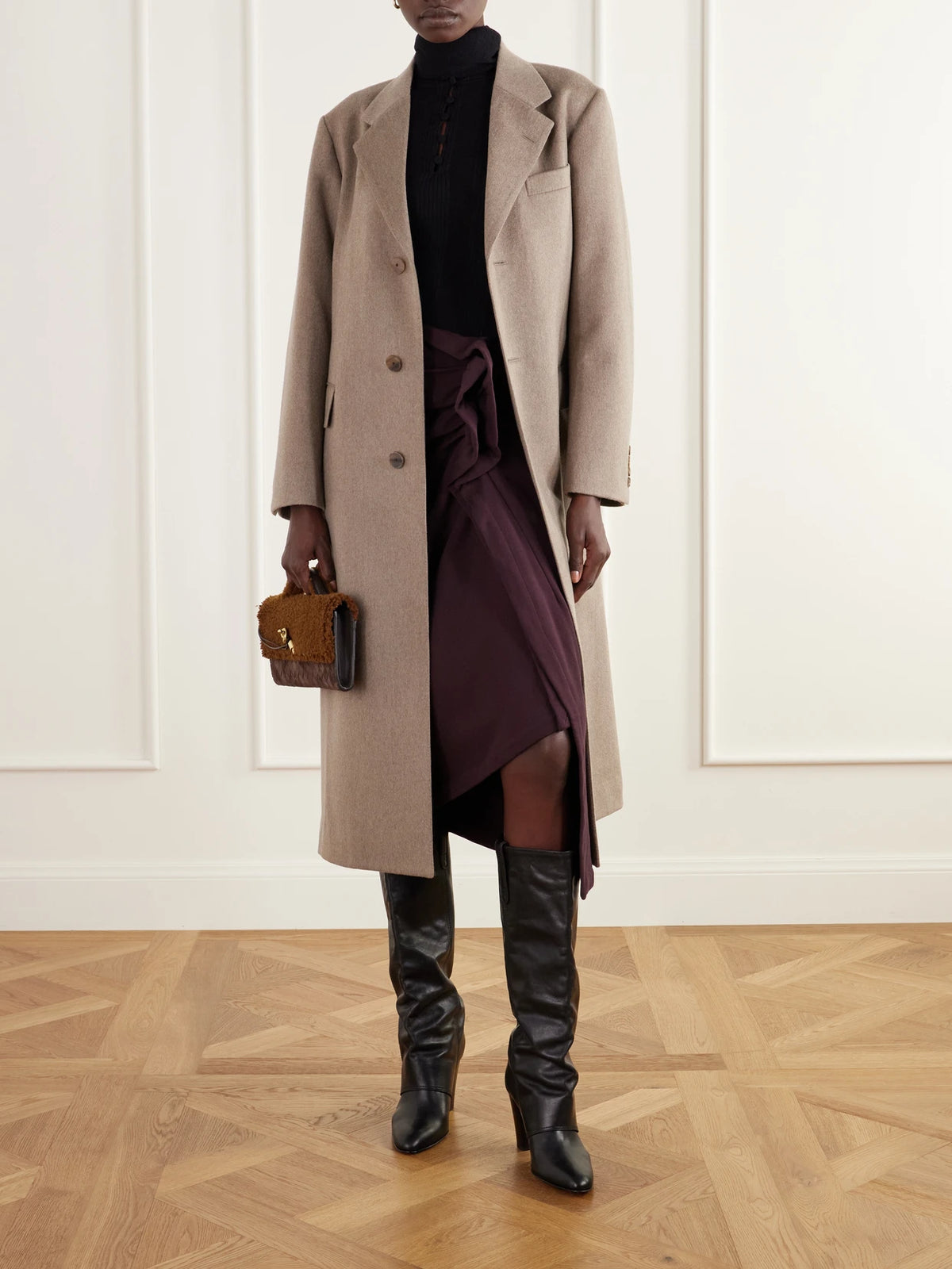 Image of a model wearing Outerwear. Product name - Scarf-detailed Ribbed Wool Sweater in Black colour by brand - Tory Burch