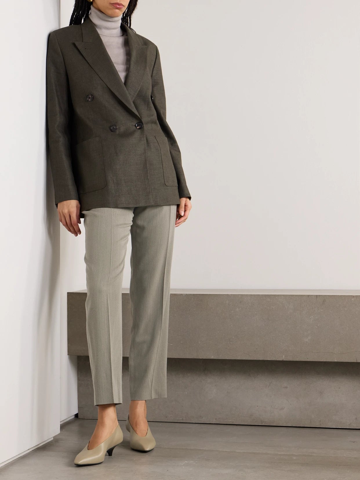 Image of a model wearing Pants. Product name - Hudson Cropped Pleated Wool Tapered Pants in Gray colour by brand - Loro Piana