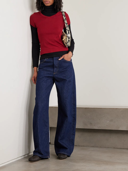 Image of a model wearing Tops. Product name - Dinah Ribbed Organic Cotton-jersey Turtleneck Top in Black colour by brand - FLORE FLORE