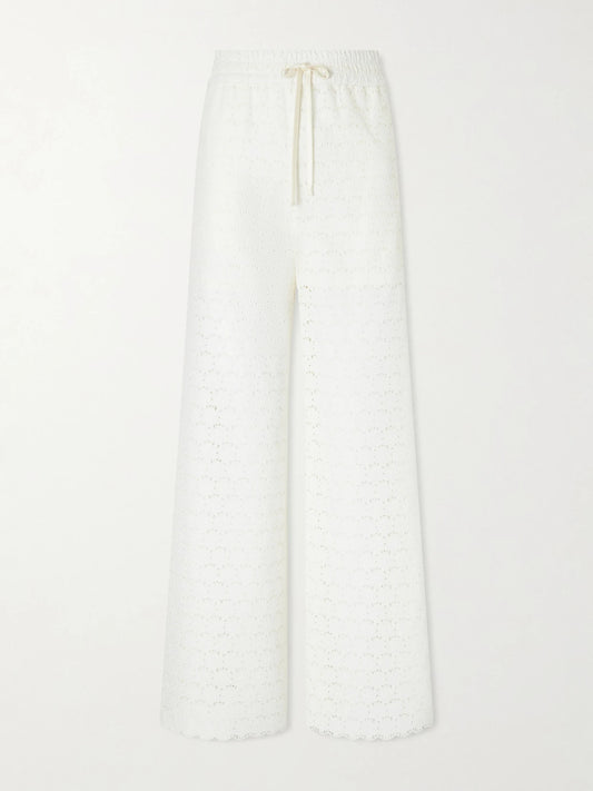 Image of a model wearing Pants. Product name - Mossi Broderie Anglaise Cotton Straight-leg Pants in Ivory colour by brand - Valentino Garavani