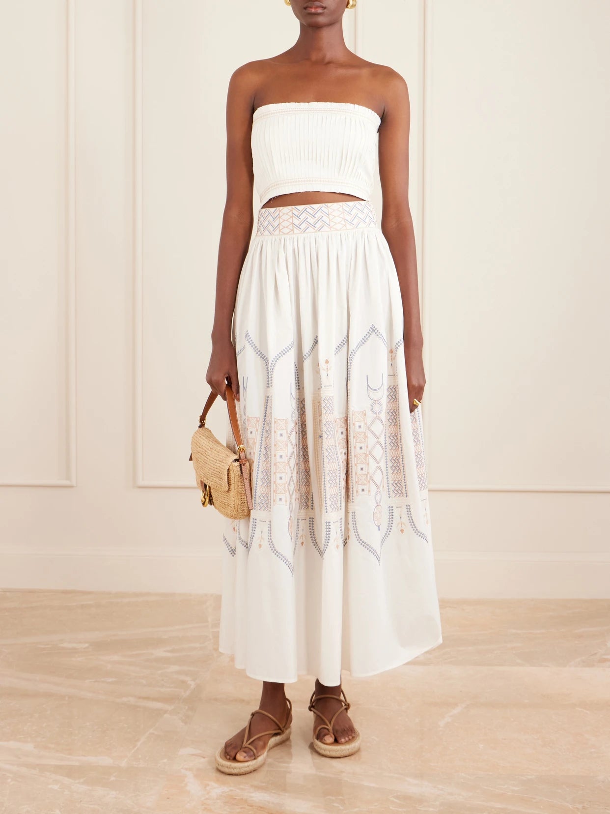 Image of a model wearing Skirts. Product name - Ombretta Embroidered Cotton-blend Poplin Midi Skirt in White colour by brand - Emporio Sirenuse