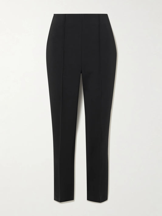 Image of a model wearing Pants. Product name - Pintucked Grain De Poudre Skinny Pants in Black colour by brand - RÓHE