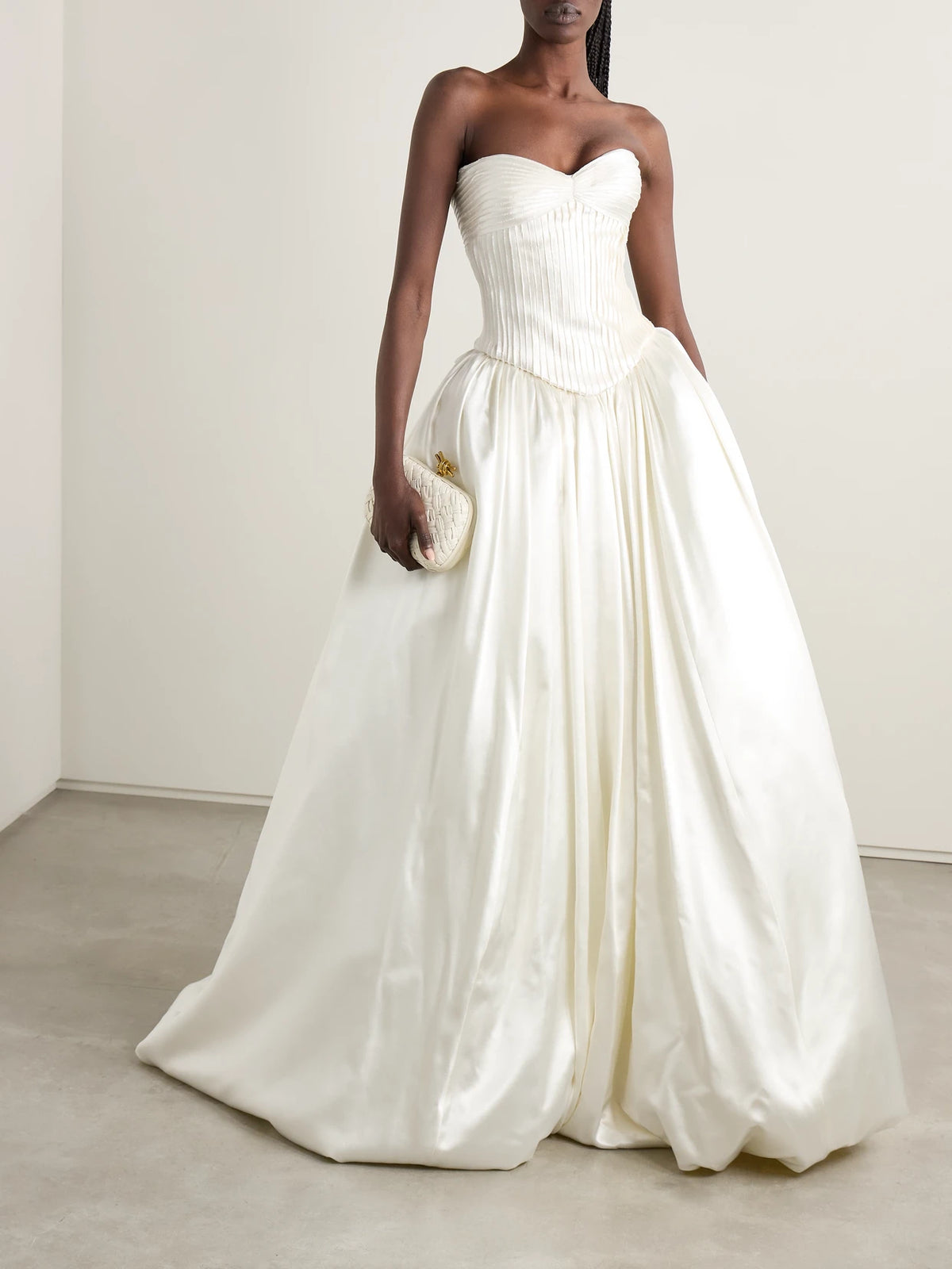 Image of a model wearing Tops. Product name - Ella Strapless Frayed Pintucked Silk And Wool-blend Satin Bustier Top in Off-white colour by brand - Danielle Frankel
