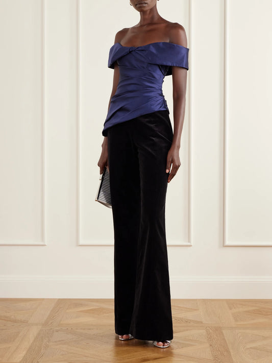 Image of a model wearing Tops. Product name - Devina Off-the-shoulder Draped Duchess-satin Blouse in Navy colour by brand - Costarellos