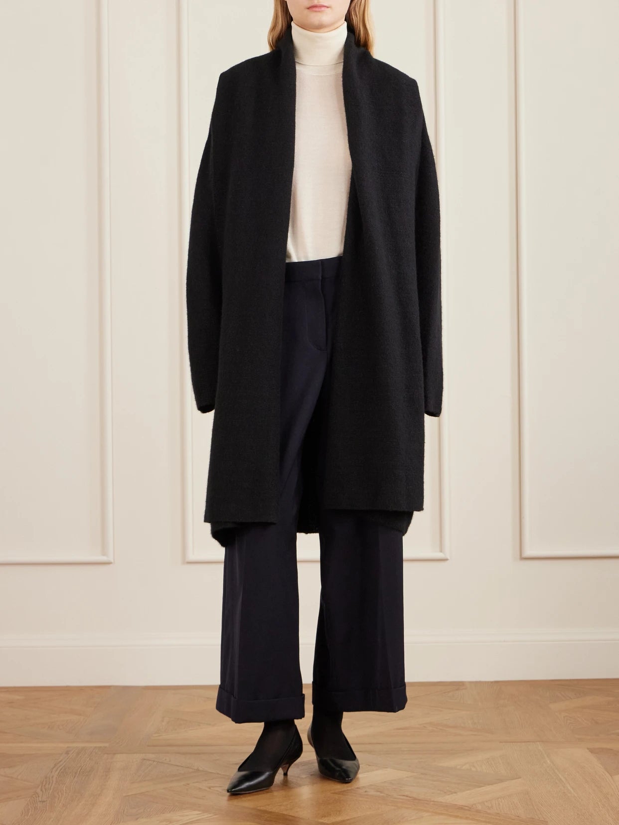 Image of a model wearing Outerwear. Product name - Novaan Cashmere And Silk-blend Cardigan in Black colour by brand - The Row
