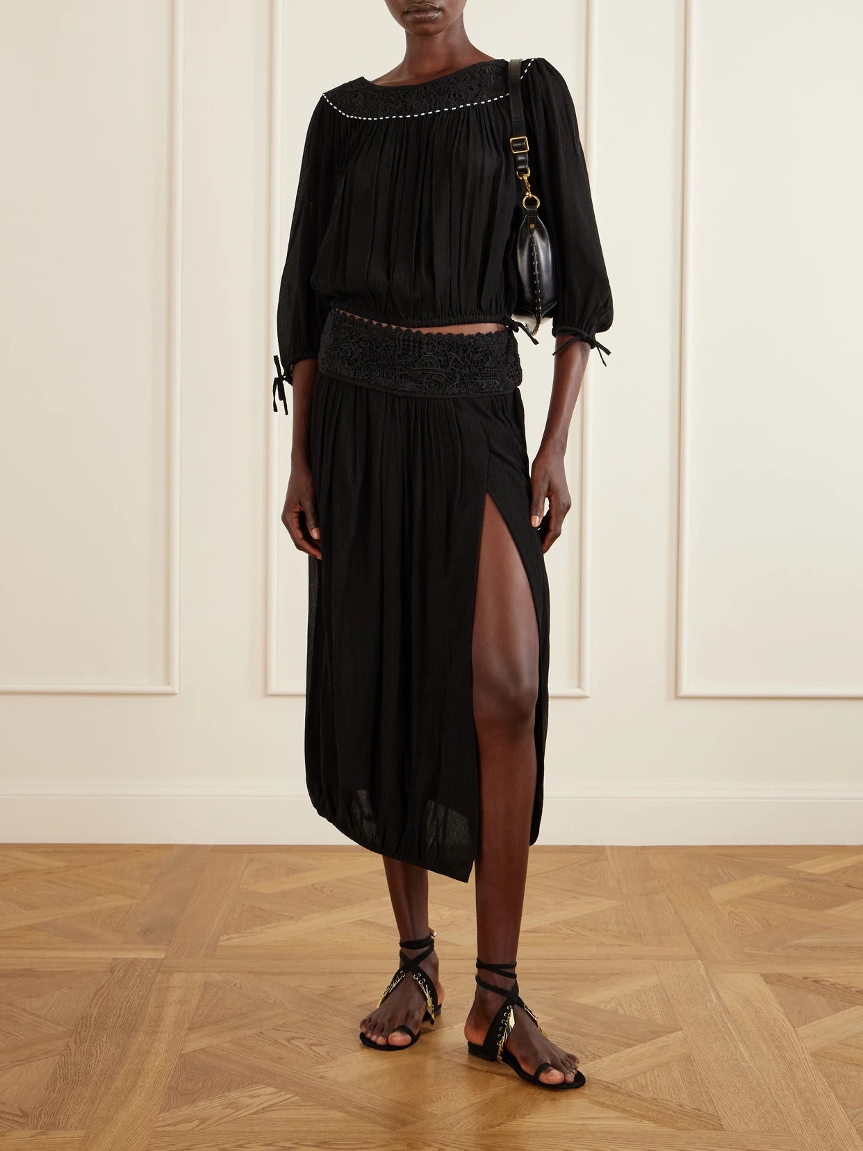 Image of a model wearing Skirts. Product name - Nilma Lace-trimmed Silk Midi Skirt in Black colour by brand - ISABEL MARANT