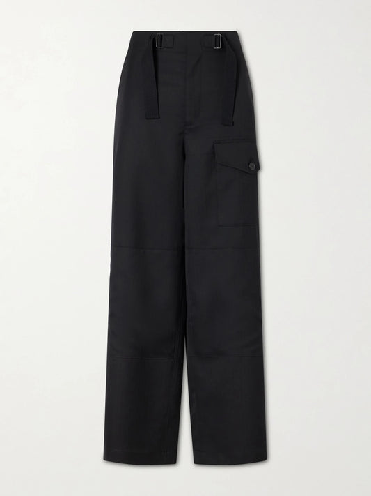 Image of a model wearing Pants. Product name - Herringbone Wool Wide-leg Cargo Pants in Black colour by brand - Auralee