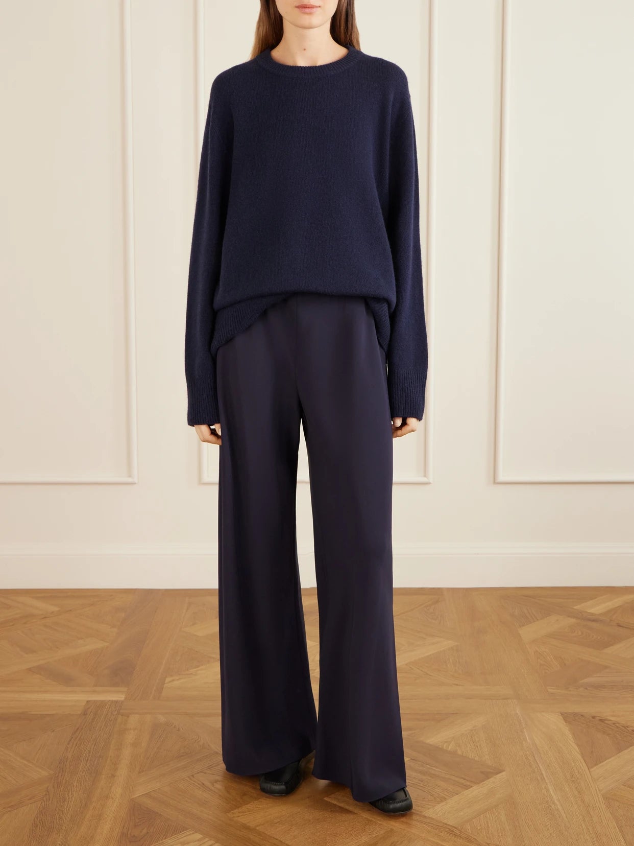 Image of a model wearing Pants. Product name - Cady Straight-leg Pants in Navy colour by brand - The Row