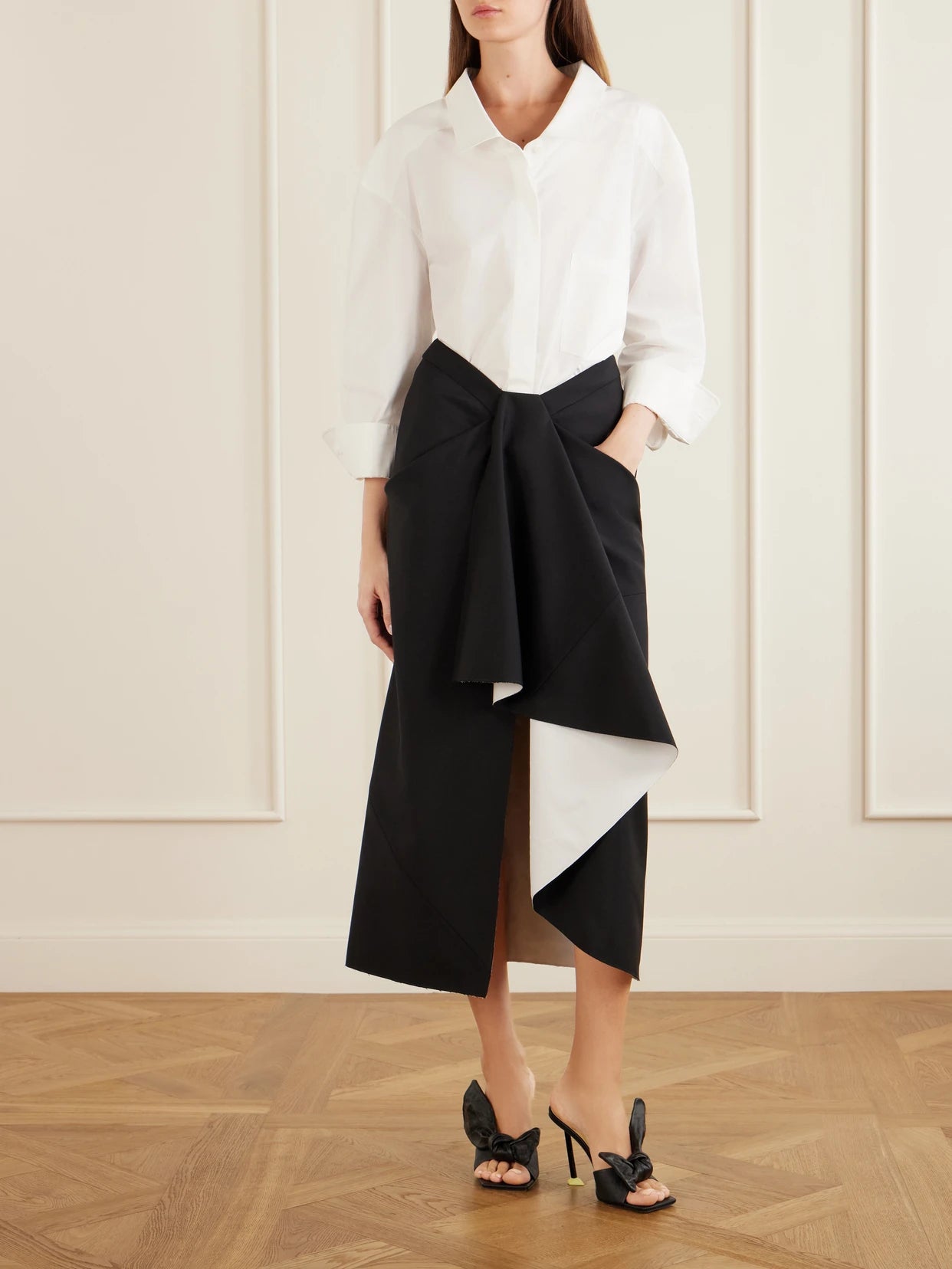 Image of a model wearing Skirts. Product name - Wool And Mohair-blend Maxi Wrap Skirt in Black colour by brand - Givenchy