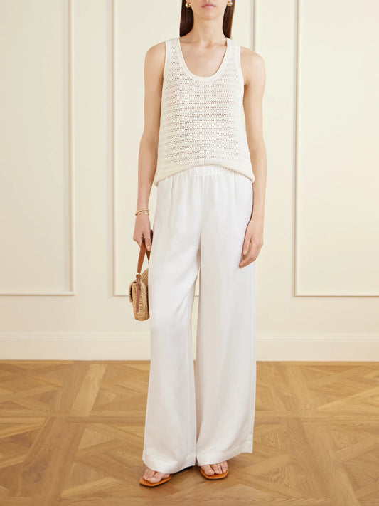 Image of a model wearing Pants. Product name - Roslyn Woven Wide-leg Pants in Ivory colour by brand - Anine Bing
