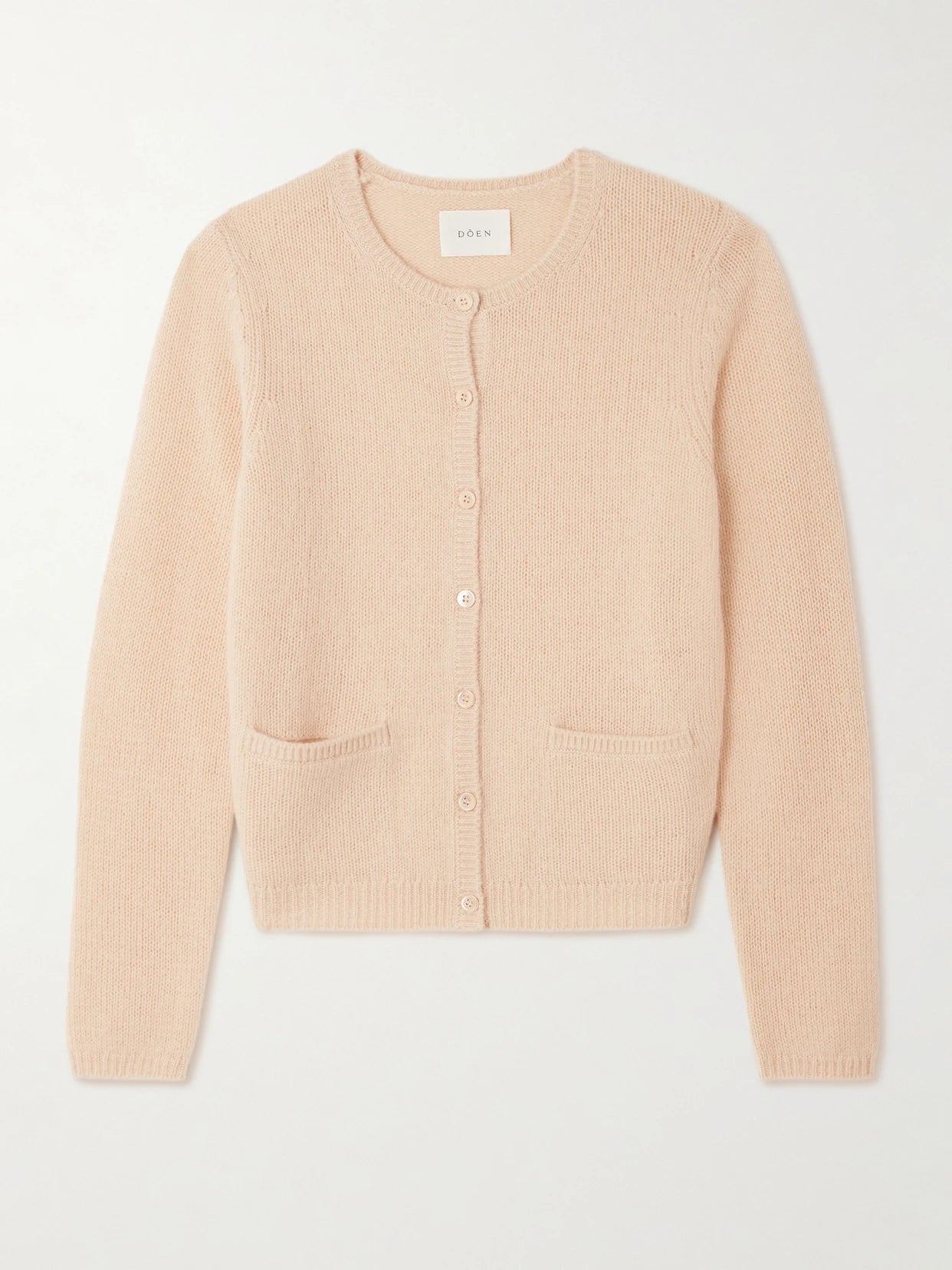 Image of a model wearing Outerwear. Product name - Thea Cashmere Cardigan in Peach colour by brand - DÔEN