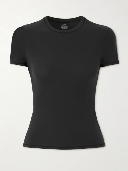 Image of a model wearing Tops. Product name - Fits Everybody T-shirt - Onyx in Black colour by brand - SKIMS