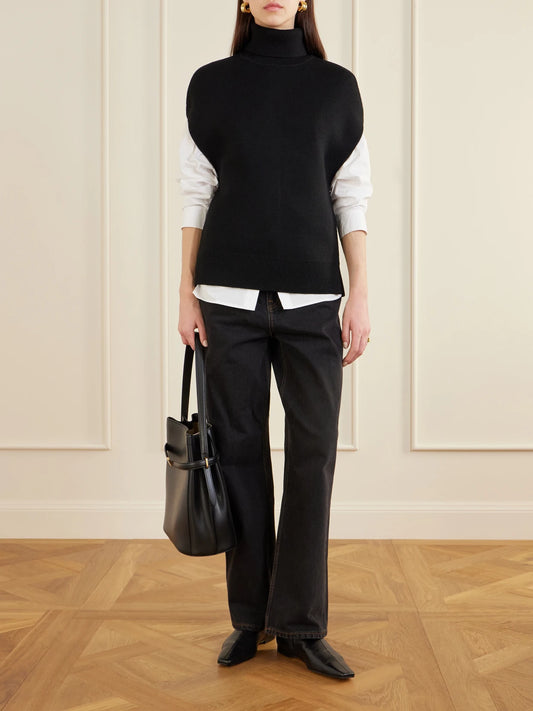 Image of a model wearing Outerwear. Product name - Wool-blend Turtleneck Sweater in Black colour by brand - TOTEME