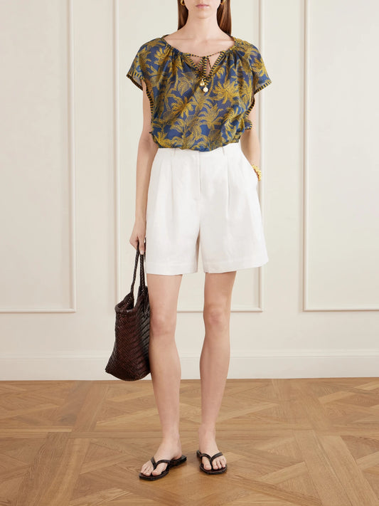 Image of a model wearing Tops. Product name - Crocodile Embellished Printed Cotton-voile Blouse in Navy colour by brand - Eres
