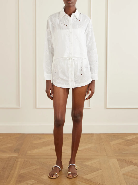 Image of a model wearing Tops. Product name - Simone Cropped Broderie Anglaise Cotton Shirt in Ivory colour by brand - Kiki de Montparnasse
