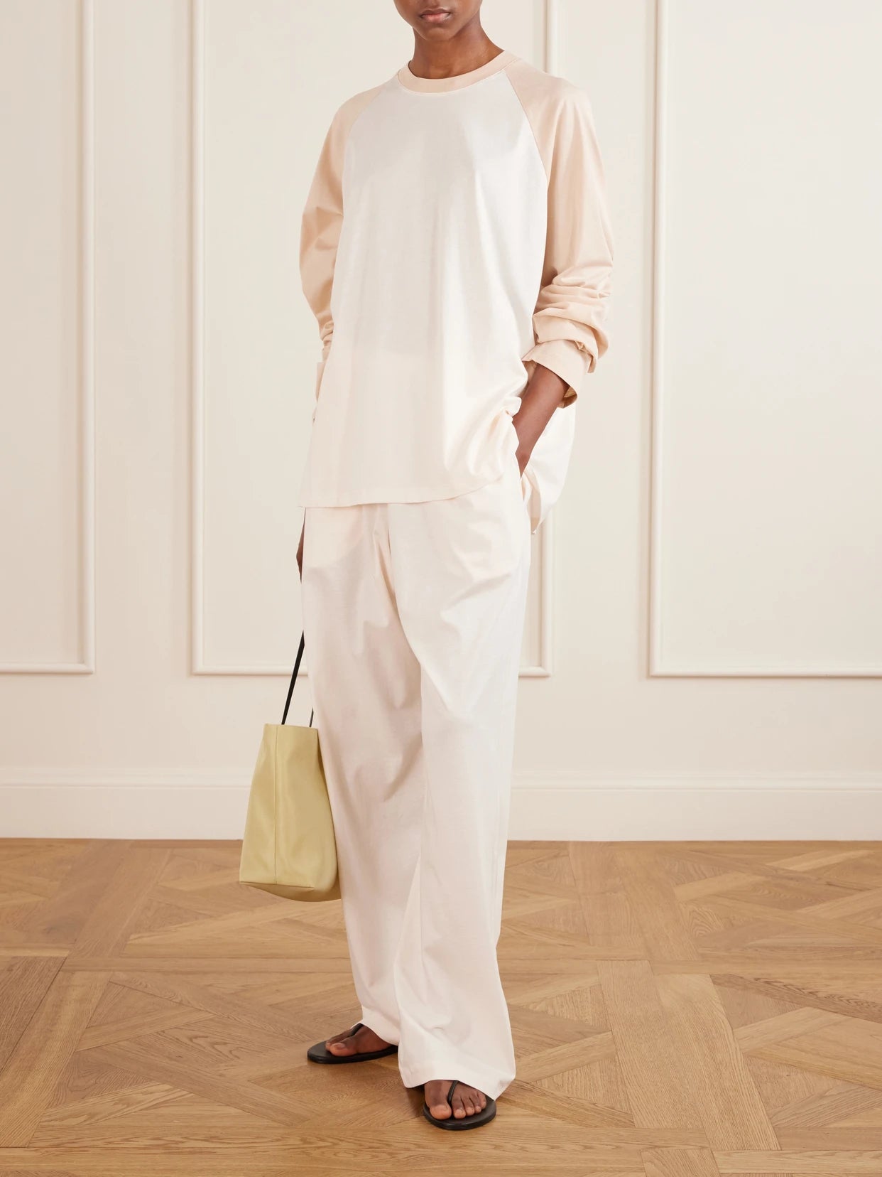 Image of a model wearing Tops. Product name - Raglan Cotton-jersey T-shirt in Blush colour by brand - WARDROBE. NYC