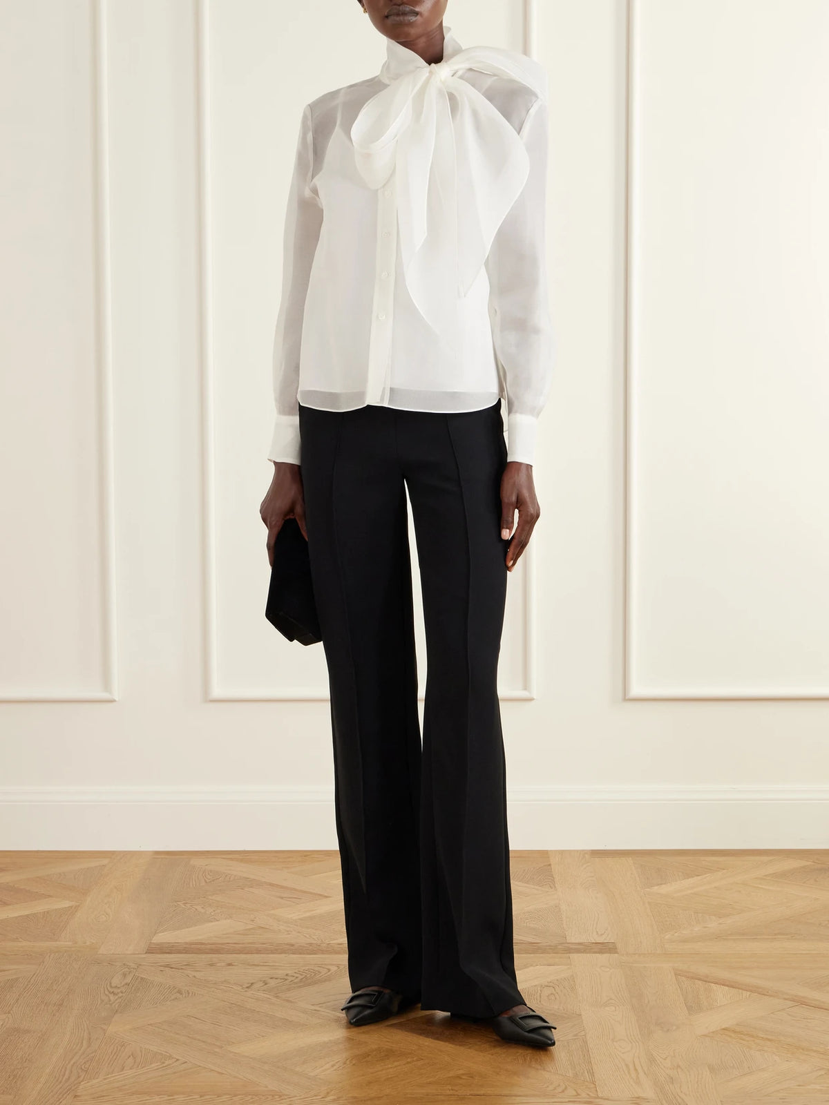 Image of a model wearing Tops. Product name - Pussy-bow Silk-organza Blouse in White colour by brand - Carolina Herrera