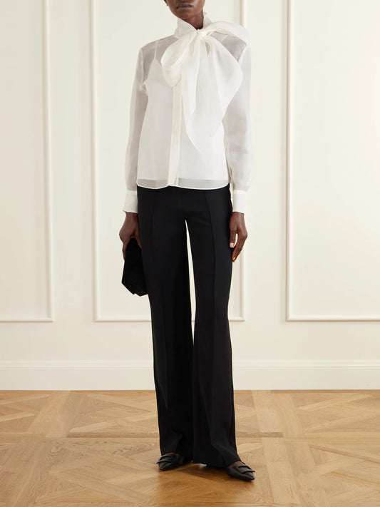 Image of a model wearing Tops. Product name - Pussy-bow Silk-organza Blouse in White colour by brand - Carolina Herrera