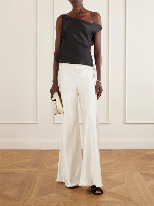 Image of a model wearing Tops. Product name - Maria Satin One-shoulder Top in Black colour by brand - Norma Kamali