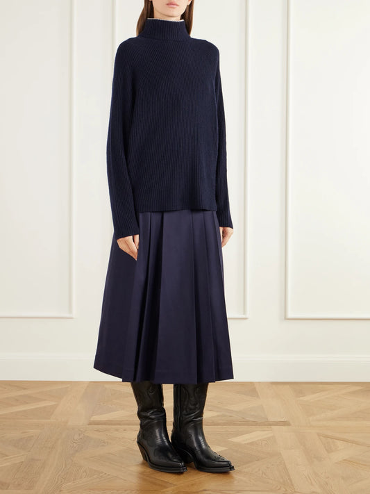 Image of a model wearing Outerwear. Product name - Tipped Wigman Ribbed Cashmere Turtleneck Sweater in Navy colour by brand - Gabriela Hearst