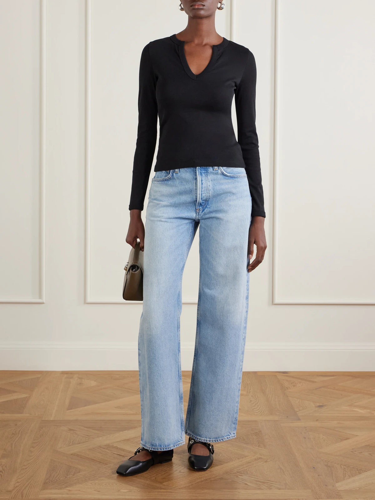 Image of a model wearing Tops. Product name - Iman Organic Cotton-jersey T-shirt in Black colour by brand - FLORE FLORE