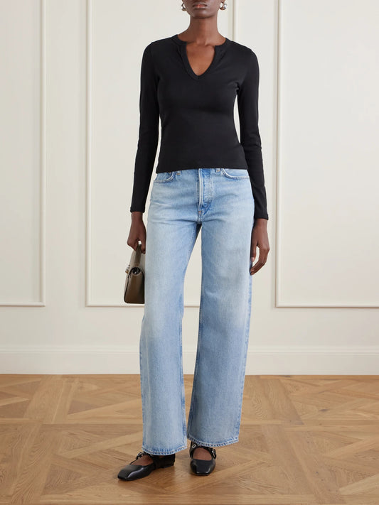 Image of a model wearing Tops. Product name - Iman Organic Cotton-jersey T-shirt in Black colour by brand - FLORE FLORE