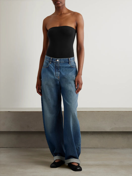 Image of a model wearing Tops. Product name - Strapless Stretch-jersey Bodysuit in Black colour by brand - Alaïa