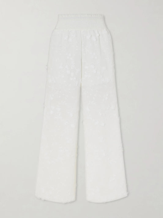 Image of a model wearing Pants. Product name - Speranza Embroidered Fil-coupé Cotton Straight-leg Pants in White colour by brand - Loretta Caponi