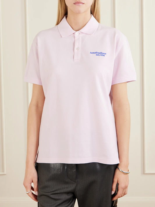 Image of a model wearing Tops. Product name - Embroidered Cotton-piqué Polo Shirt in Pink colour by brand - Acne Studios