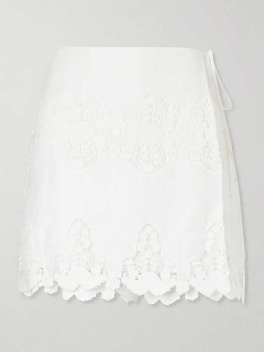 Image of a model wearing Shorts. Product name - Embroidered Cotton And Linen-blend Skort in Ivory colour by brand - Miguelina