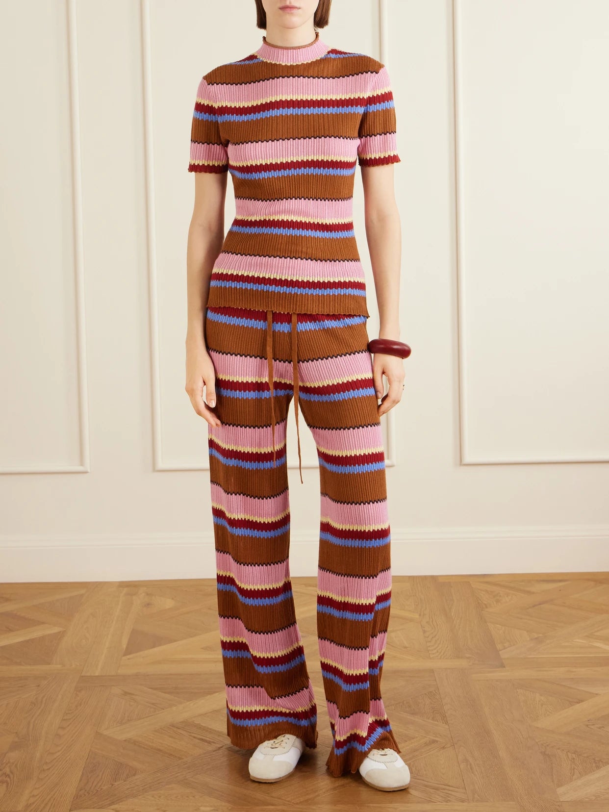 Image of a model wearing Tops. Product name - Palazzo Striped Ribbed Silk And Linen-blend Top in Pink colour by brand - Guest In Residence