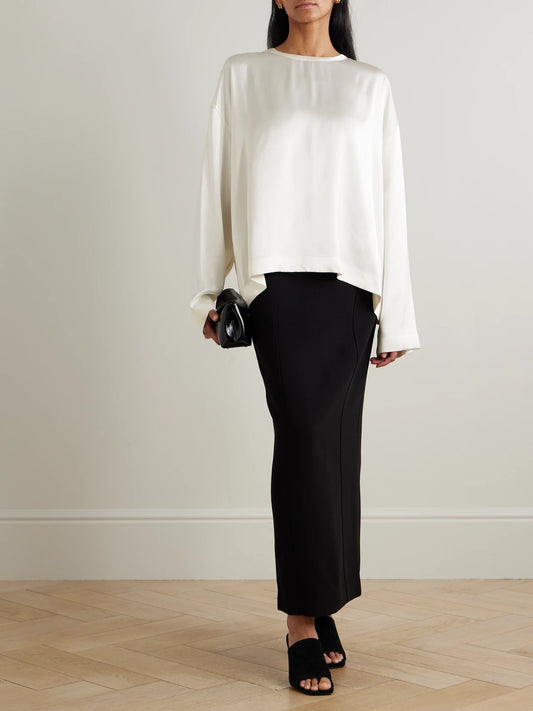 Image of a model wearing Tops. Product name - Satin Top in White colour by brand - TOTEME