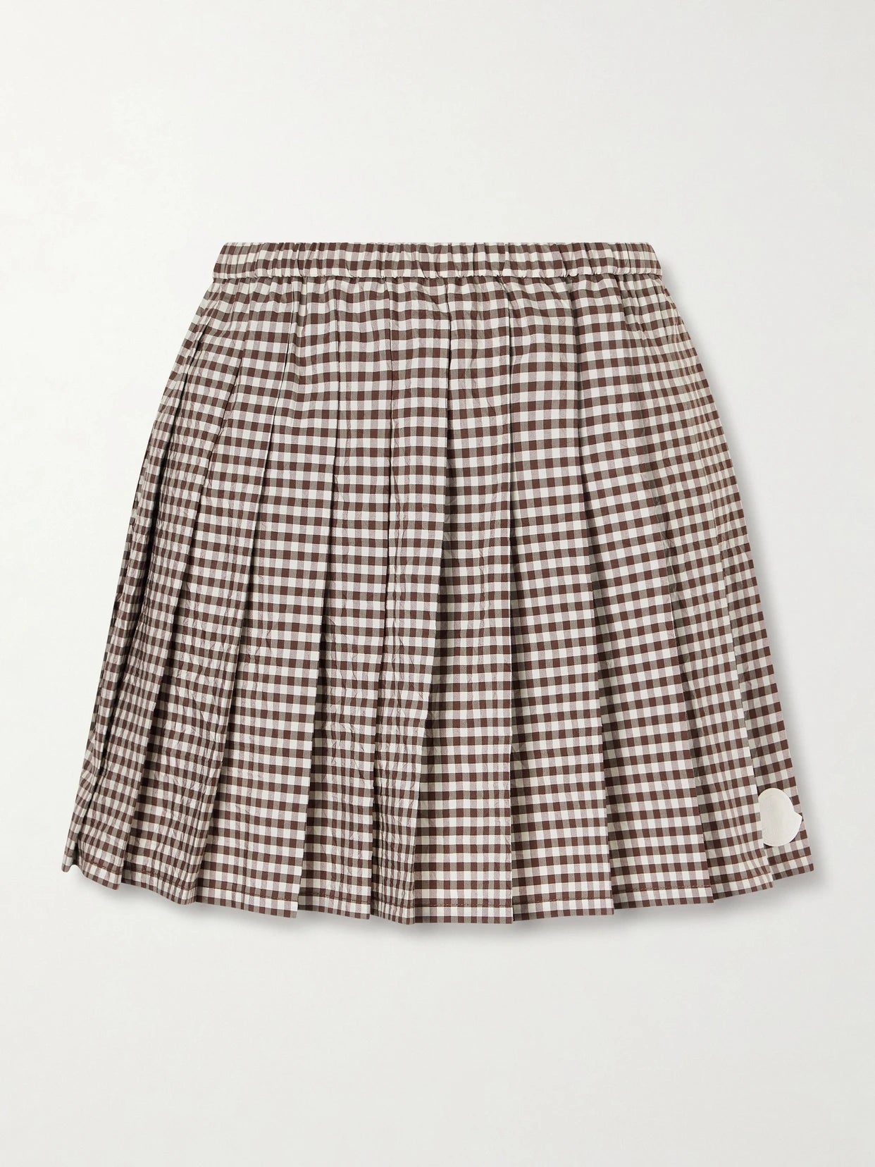 Image of a model wearing Skirts. Product name - Appliquéd Pleated Gingham Cotton-blend Mini Skirt in Brown colour by brand - Moncler