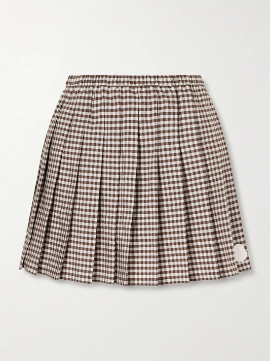 Image of a model wearing Skirts. Product name - Appliquéd Pleated Gingham Cotton-blend Mini Skirt in Brown colour by brand - Moncler