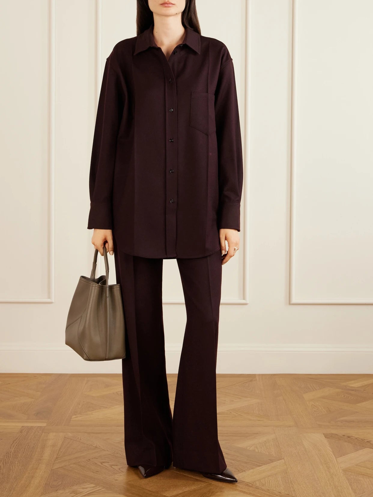 Image of a model wearing Pants. Product name - Alina Wool High-rise Straight-leg Pants in Burgundy colour by brand - Victoria Beckham
