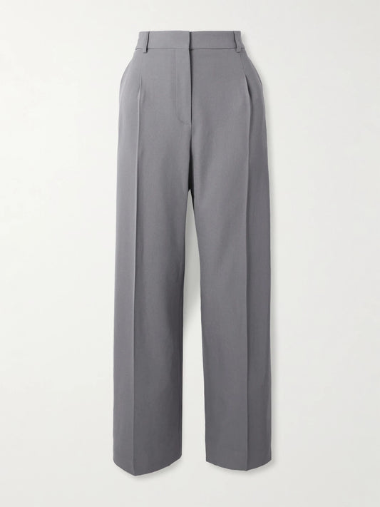 Image of a model wearing Pants. Product name - Capri Pleated Wool-gabardine Straight-leg Pants in Gray colour by brand - Alaïa